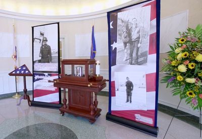 A room with a display of pictures of soldiers and flags