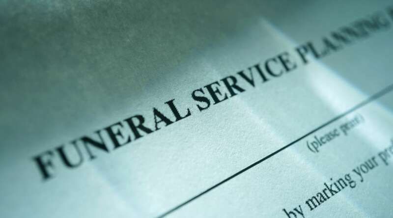 A close up of a funeral service planning form