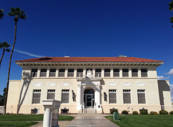A large white building with a red tile roof