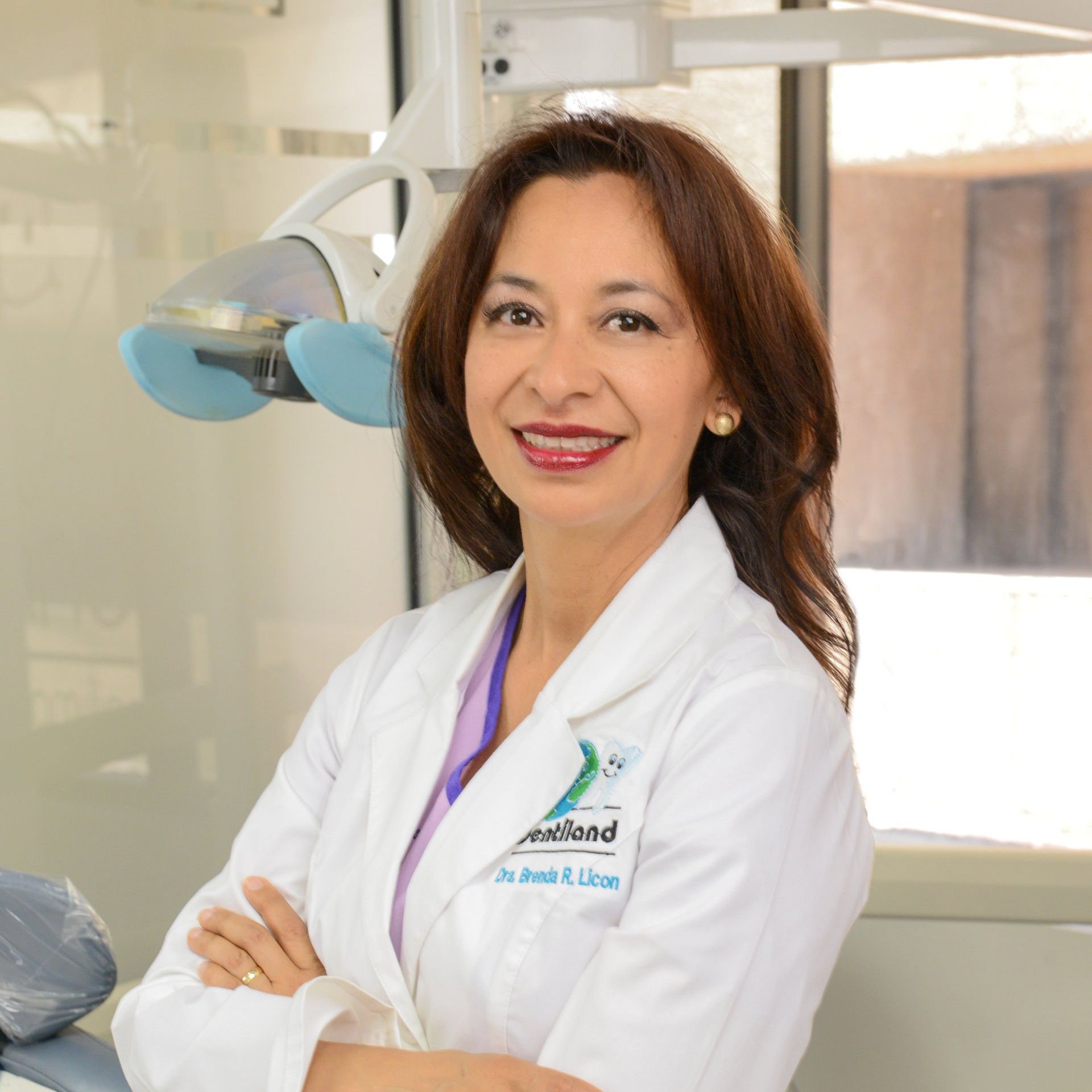 A woman in a white coat is smiling for the camera.