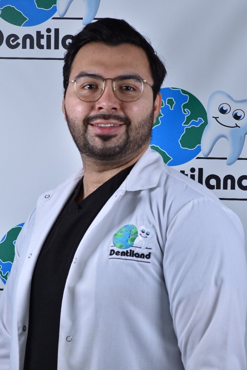 A man in a white coat with dentiland written on it