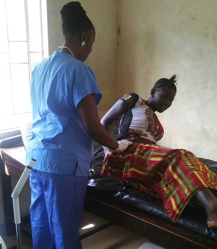 medical check up of a lady lying on bed