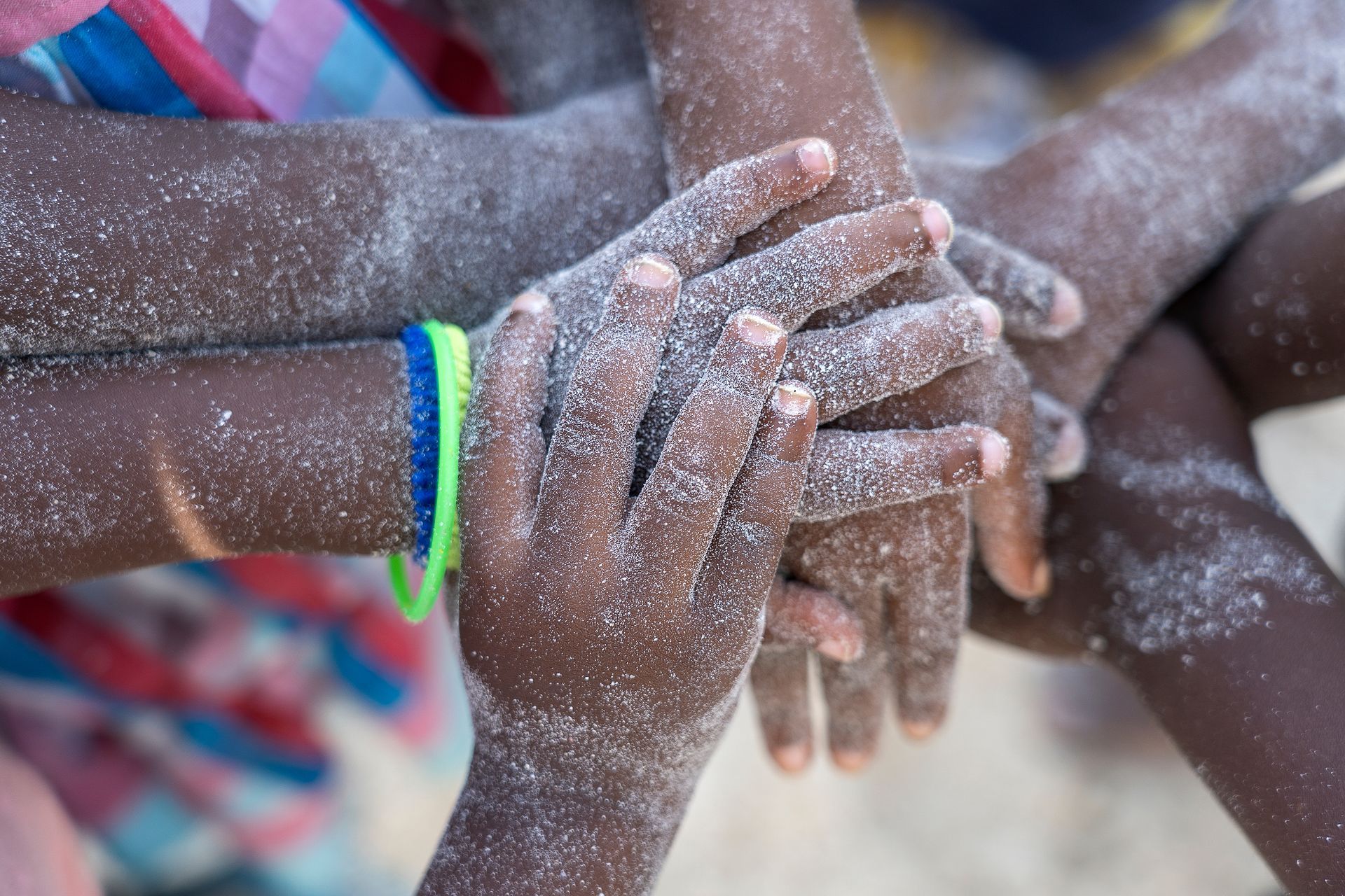 children hands with white sands