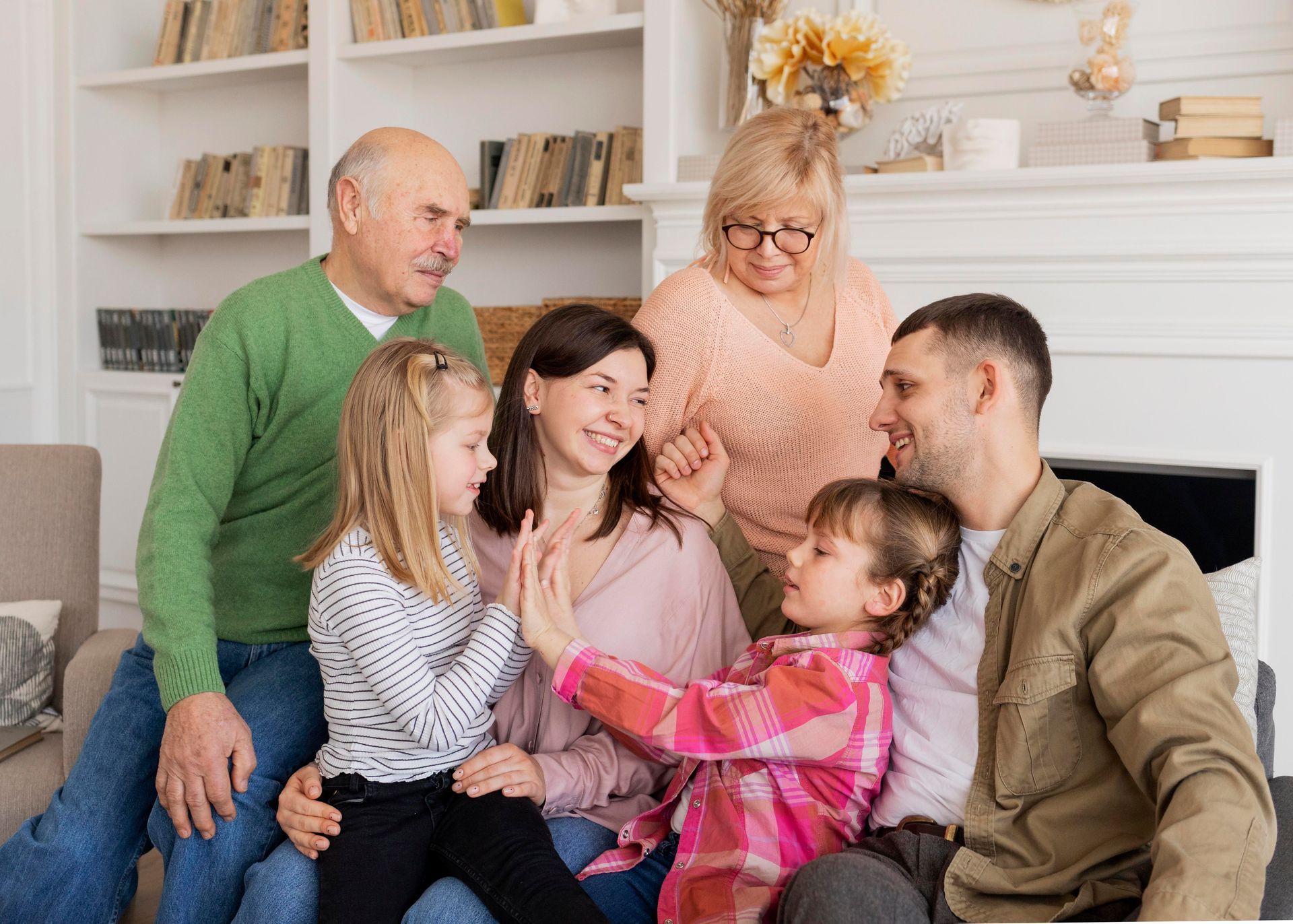 A family is sitting on a couch in a living room.