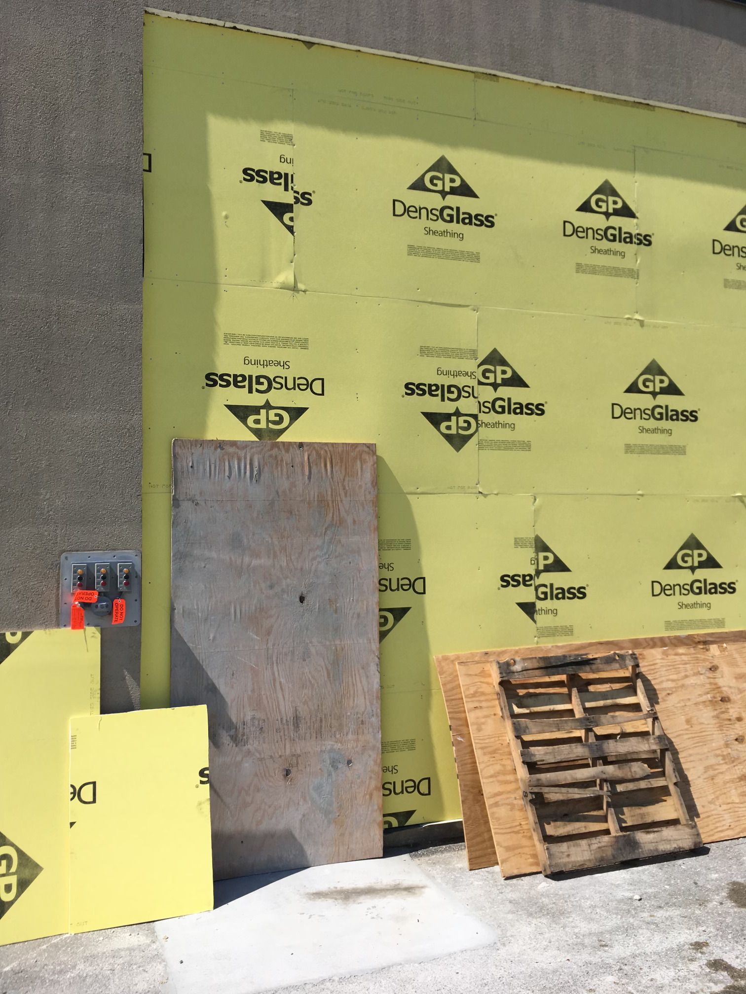 A wall with a lot of yellow sheets of denseglass
