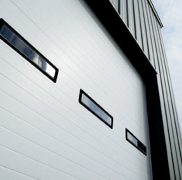 A white garage door with three windows on it