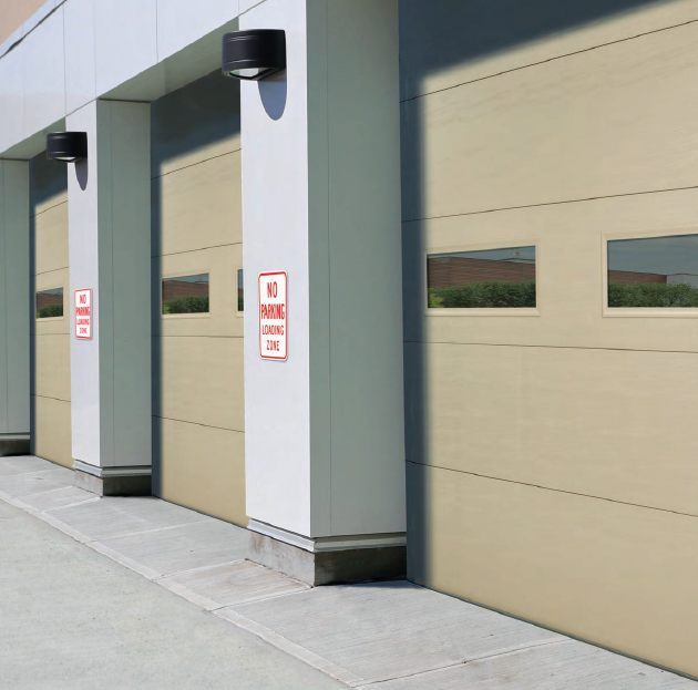 A row of garage doors with a no parking sign on the side