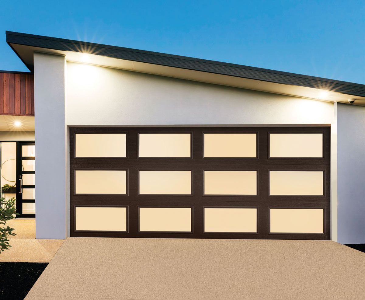 A white house with a brown garage door