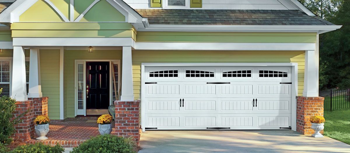 A yellow house with a white garage door