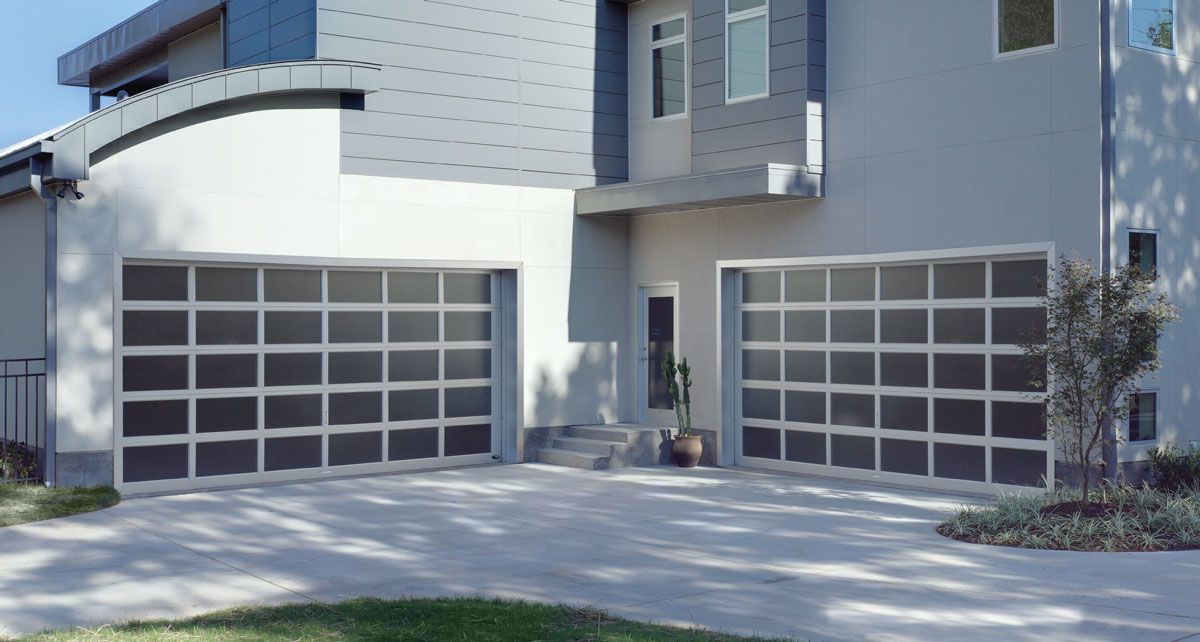 A large white house with a large garage door