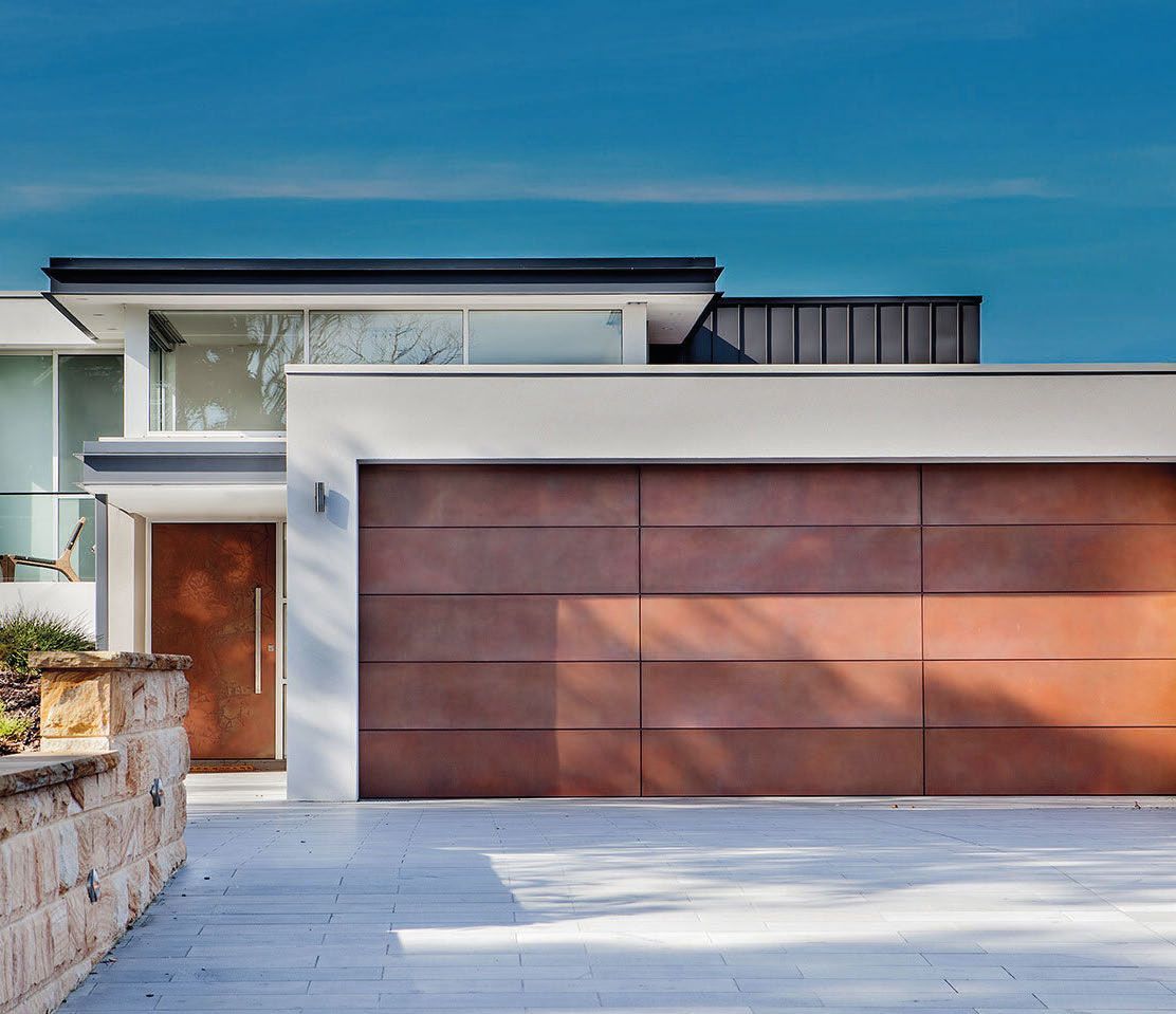 A modern house with a large brown garage door