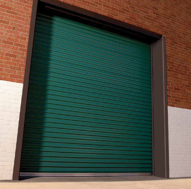 A green garage door is open on a brick building