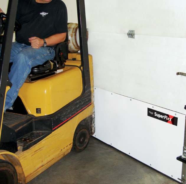 A man is driving a yellow forklift in a garage