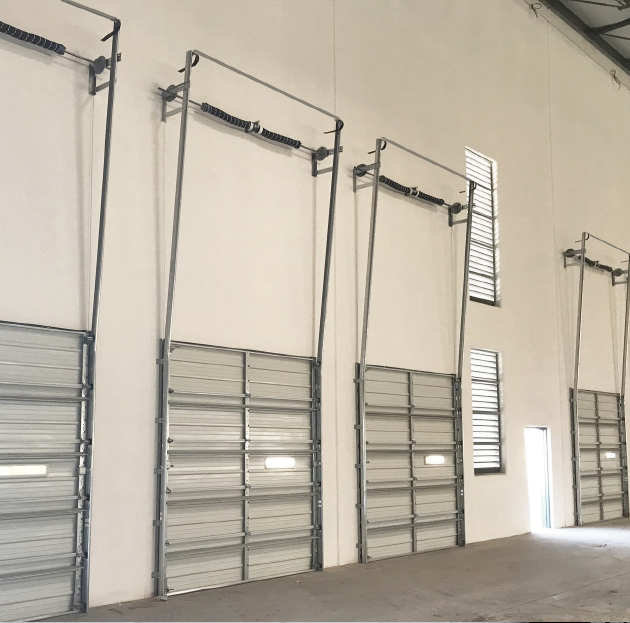 A row of garage doors in an empty building