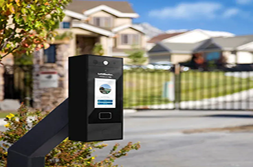 Black access control system with screen at gated community entrance.