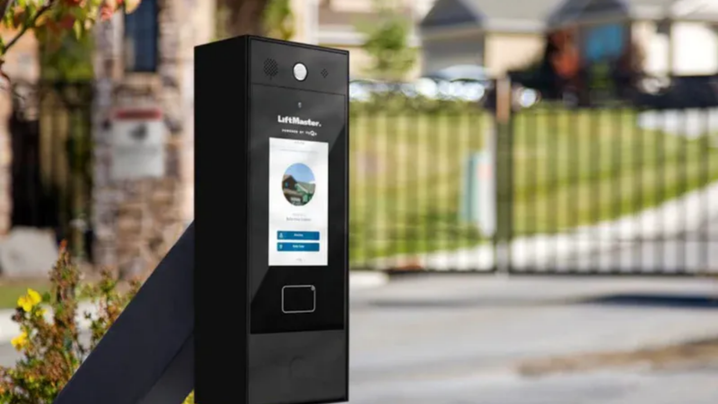 Black wire mesh fence with blurred street scene beyond. Black wire mesh fence with blurred street scene beyond.