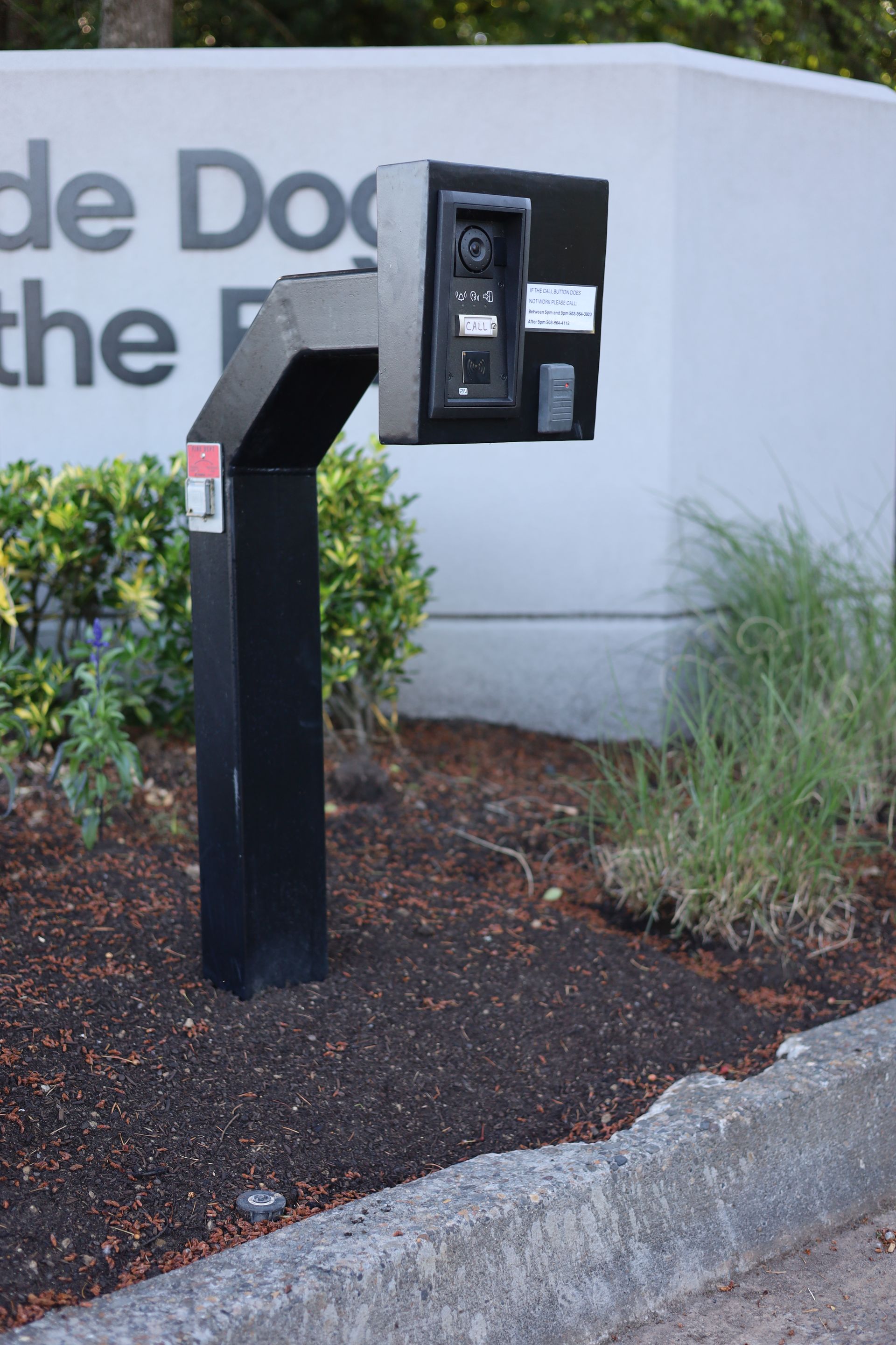 A phone booth is sitting in front of a sign that says de doc the r.