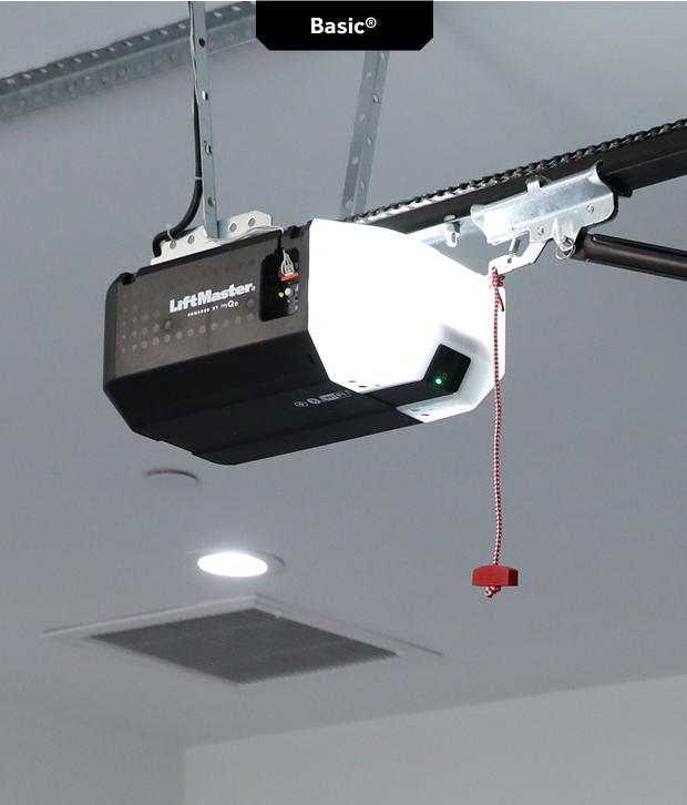 Garage door opener mounted on the ceiling with a red emergency release cord.