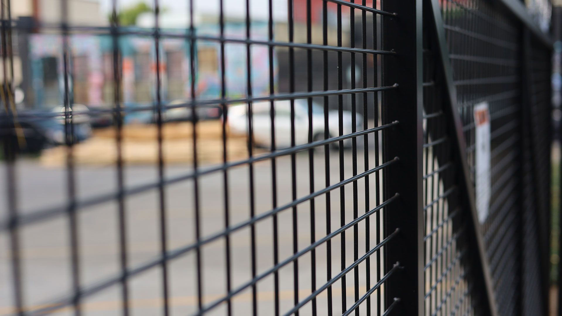 Dark gray horizontal slat gate set in a stone wall.