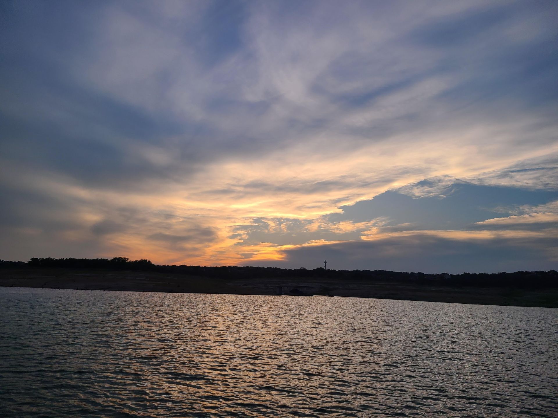 A sunset viewed from a pontoon boat on our sunset cruise on Lake Travis in Austin Texas TX.