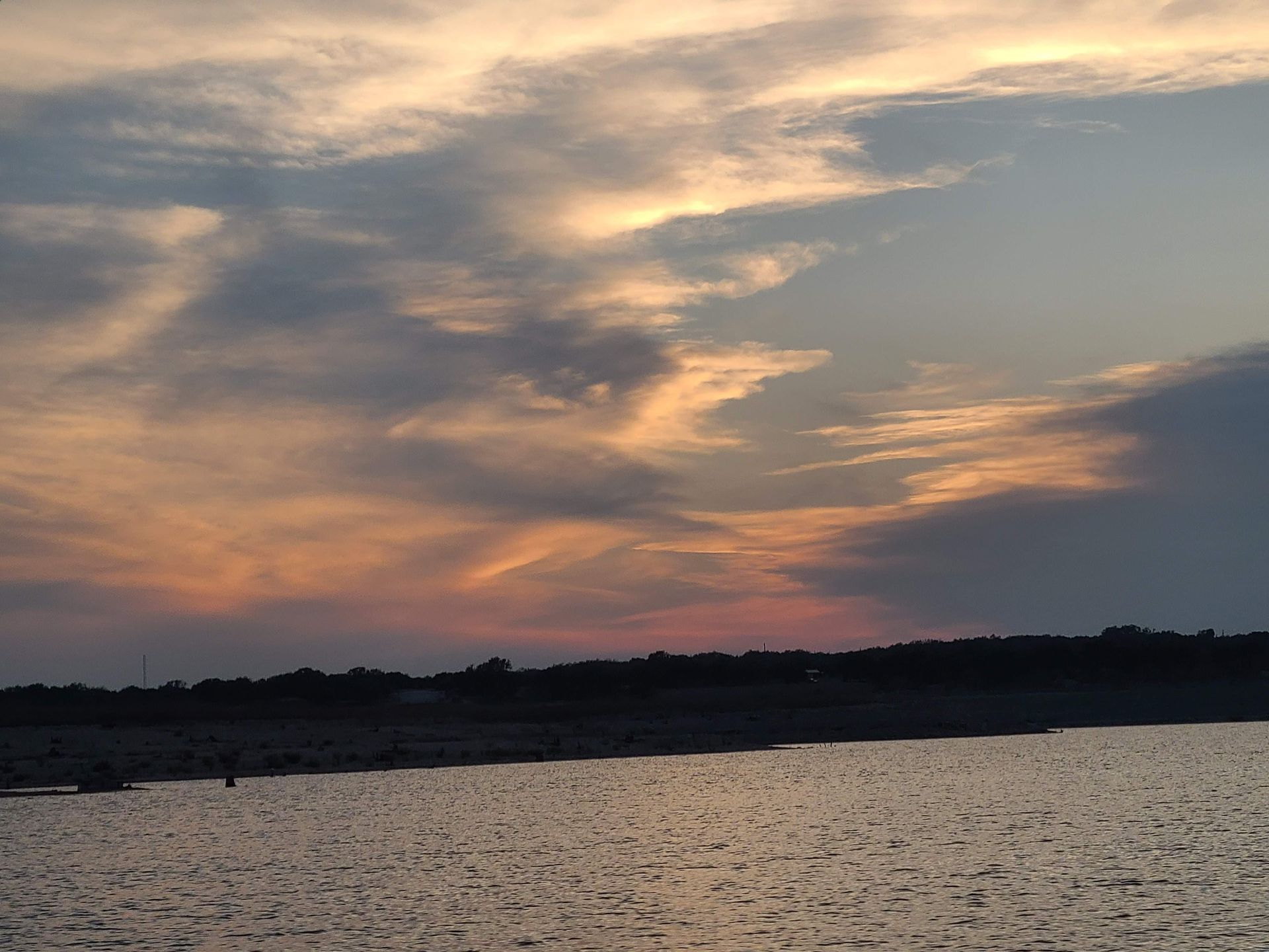 A sunset viewed from a pontoon boat on our sunset cruise on Lake Travis in Austin Texas TX