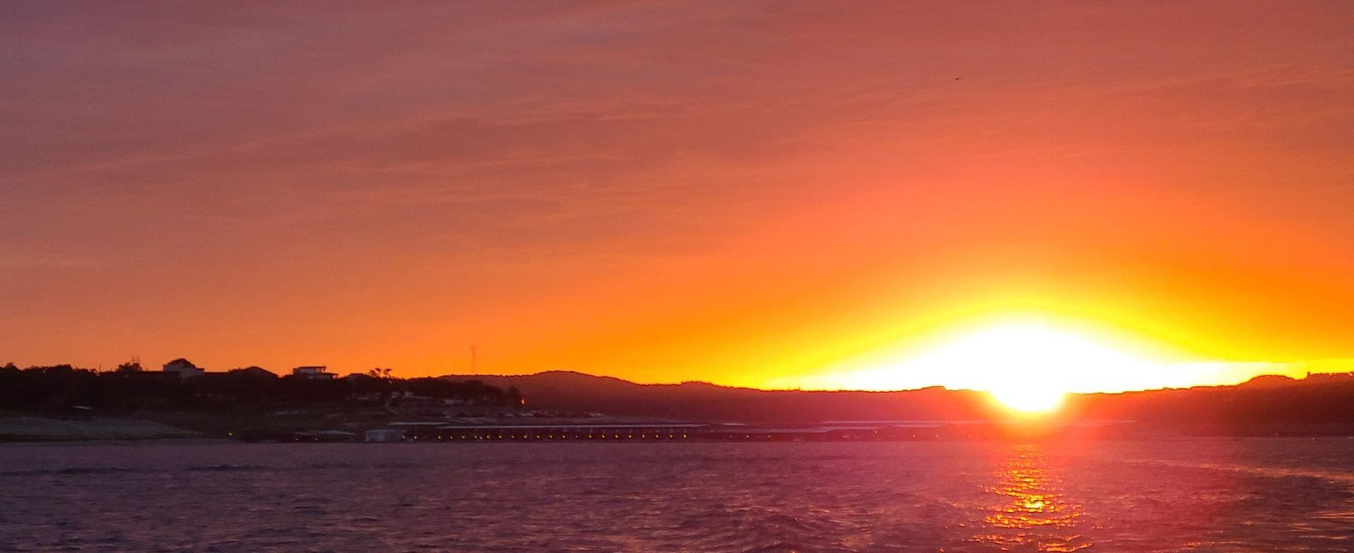 A sunset viewed from a pontoon boat on our sunset cruise on Lake Travis in Austin Texas TX