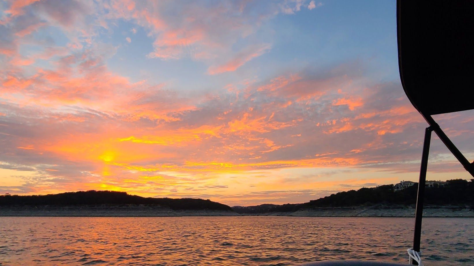 A sunset viewed from a pontoon boat on our sunset cruise on Lake Travis in Austin Texas TX