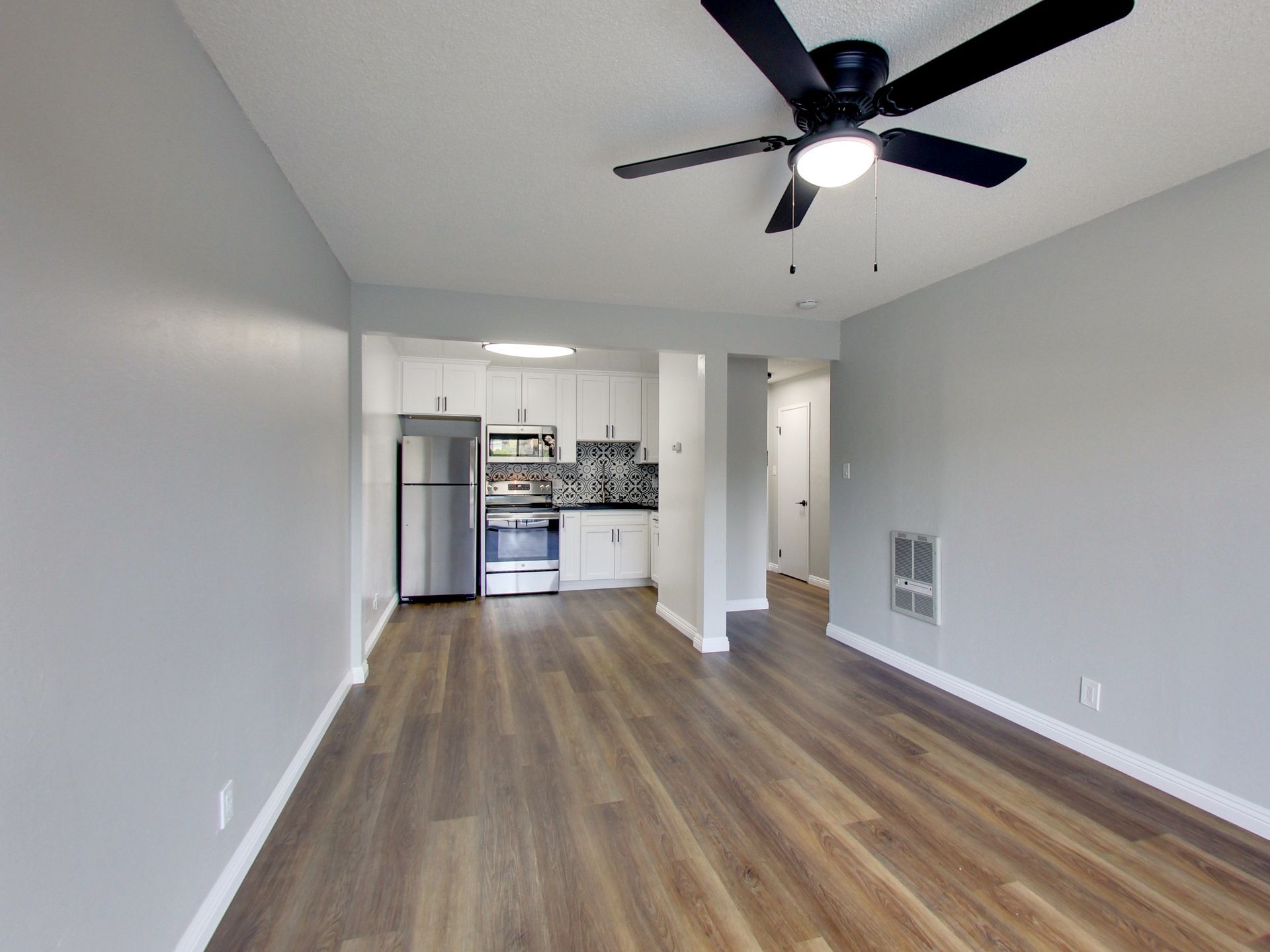 modern living room with a sofa, coffee table, bench, chair, tv and onlooking to a patio