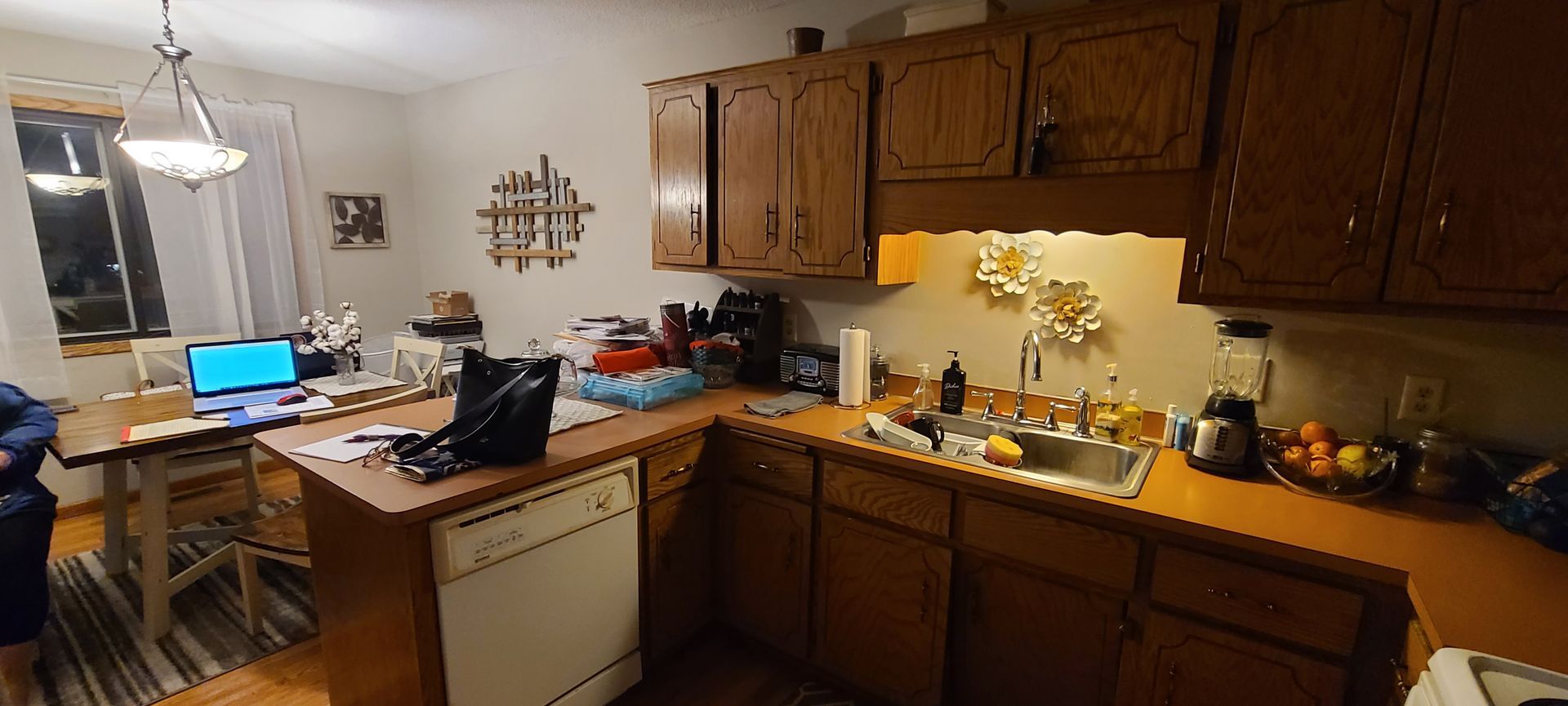 A kitchen with wooden cabinets and a sink.