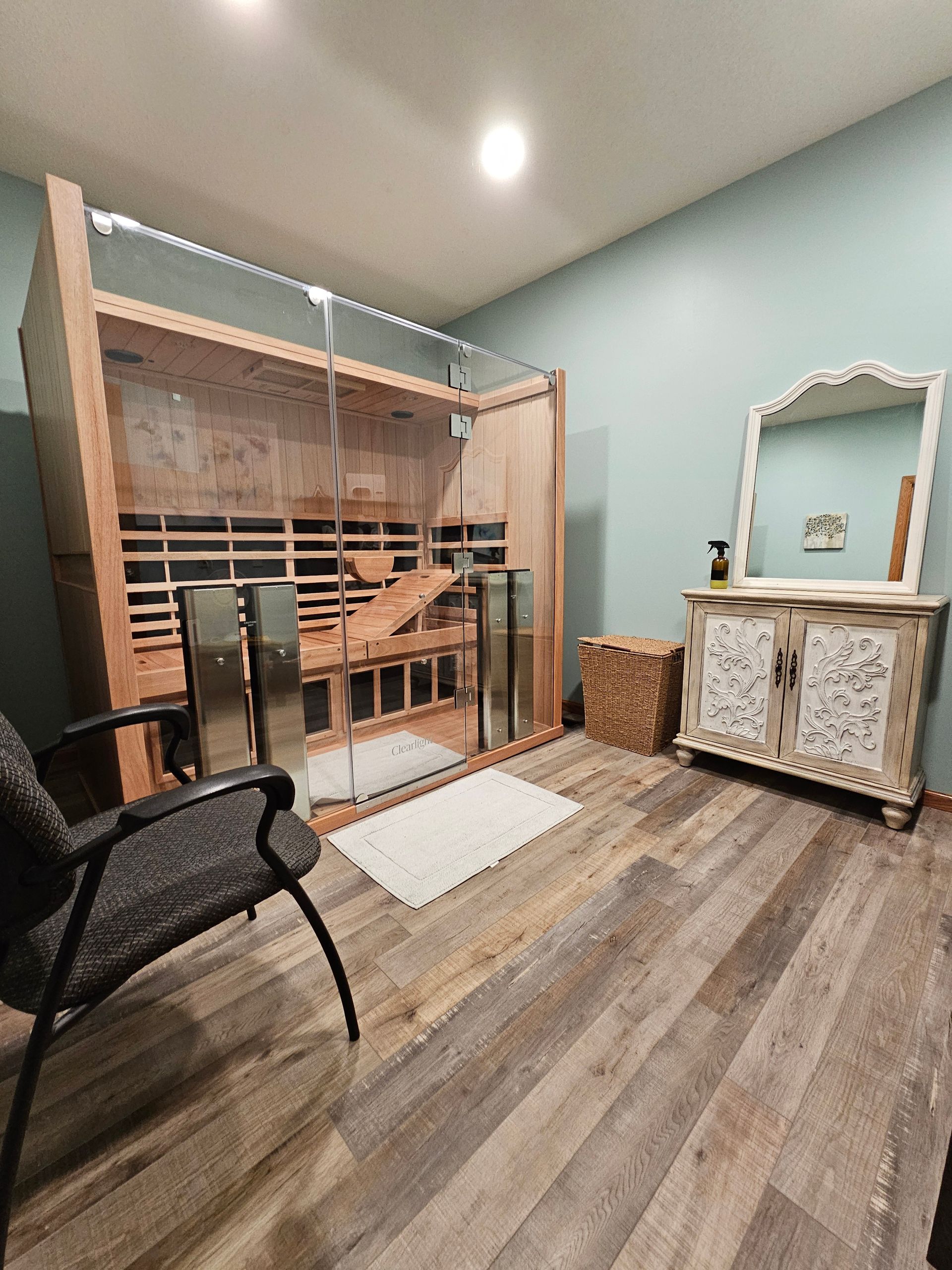 An empty basement with a fireplace and carpet