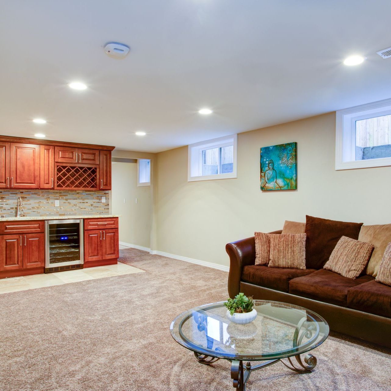 A living room with a couch , coffee table , and kitchen.