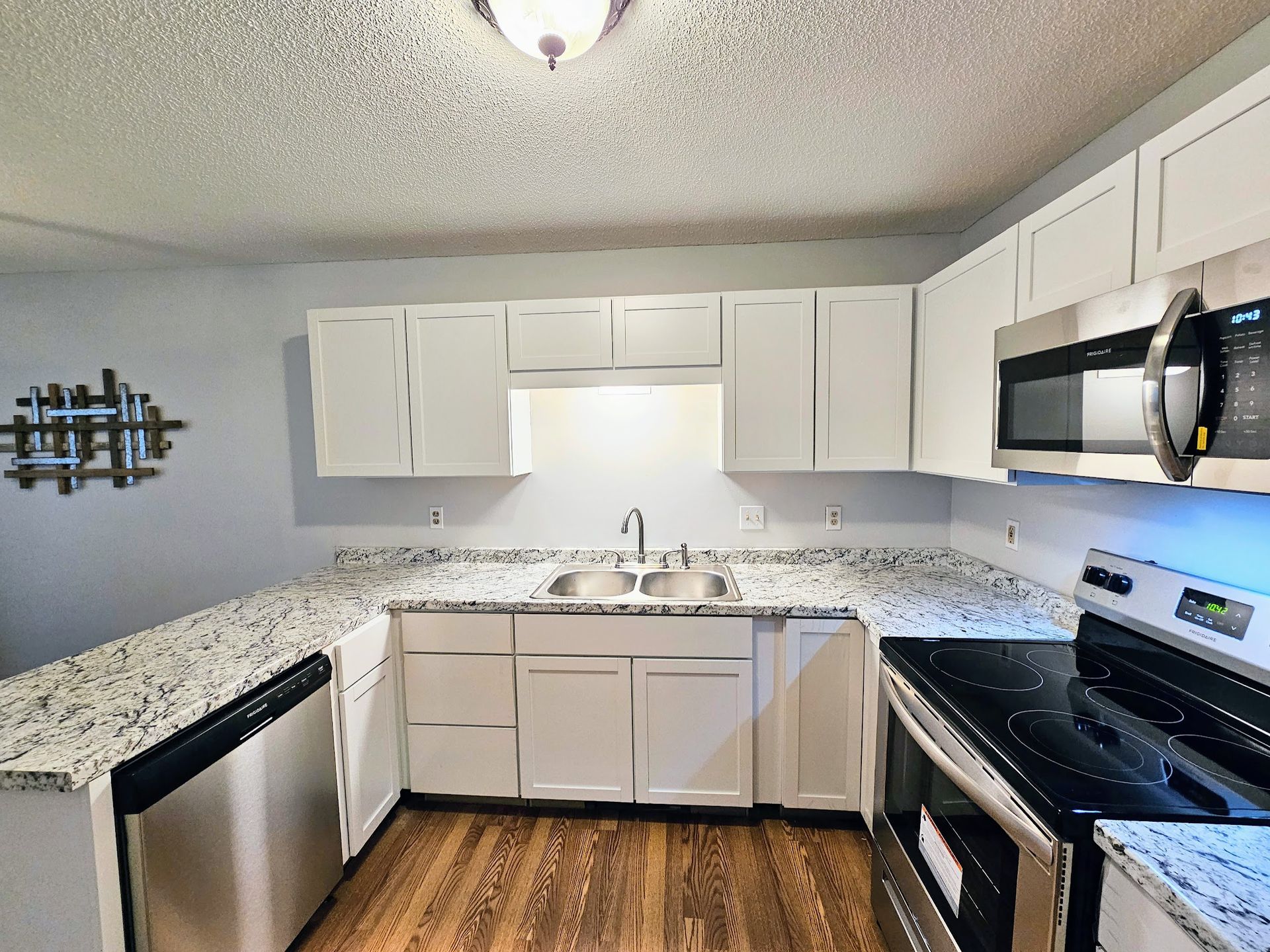 A kitchen with stainless steel appliances and white cabinets