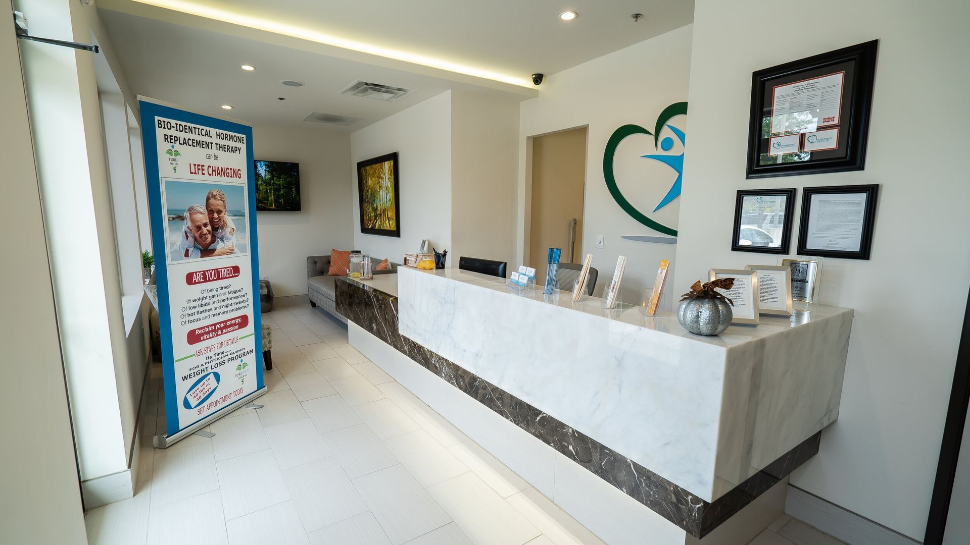 A dental office with a marble counter and a heart on the wall.
