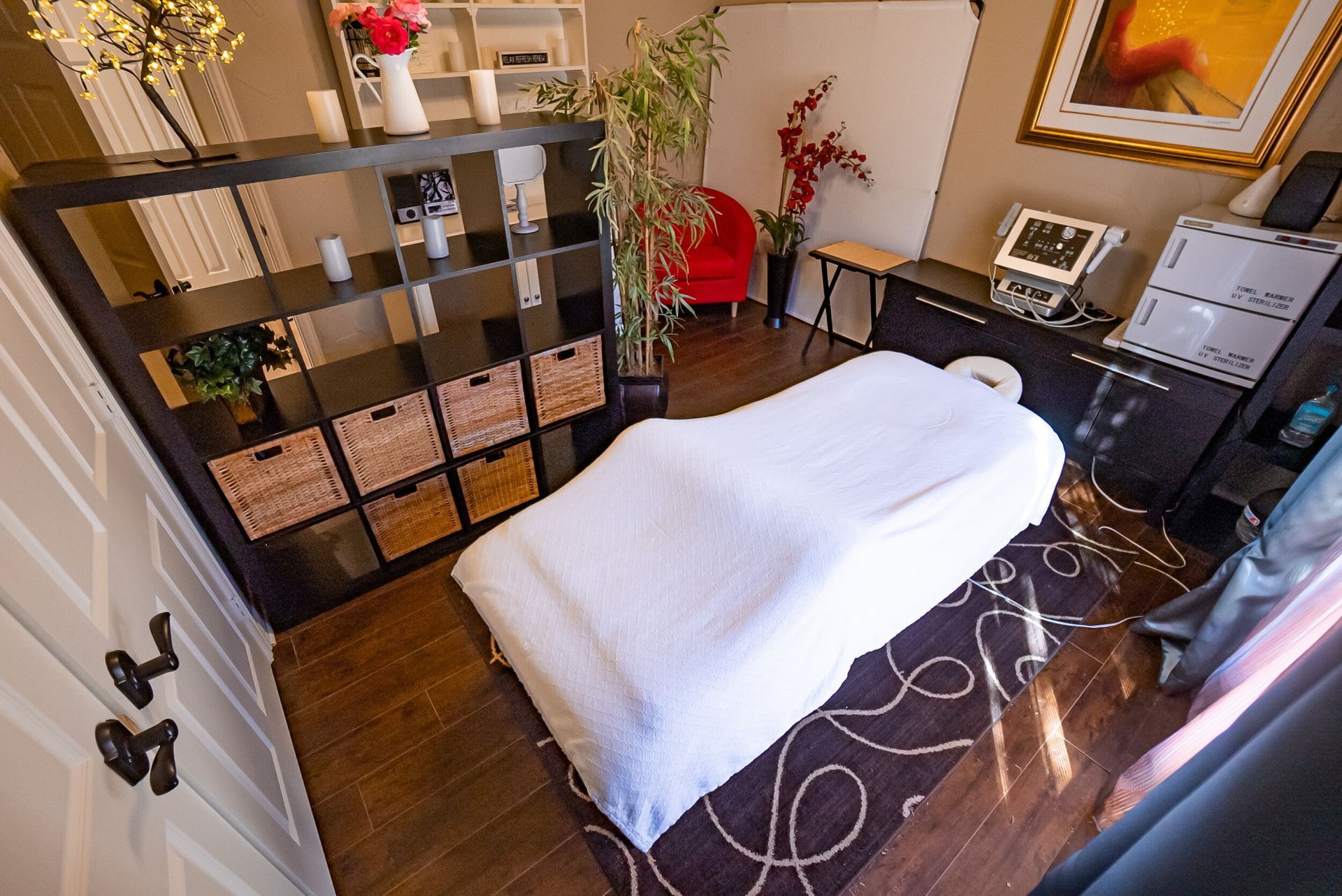 There is a massage table in the middle of the room.