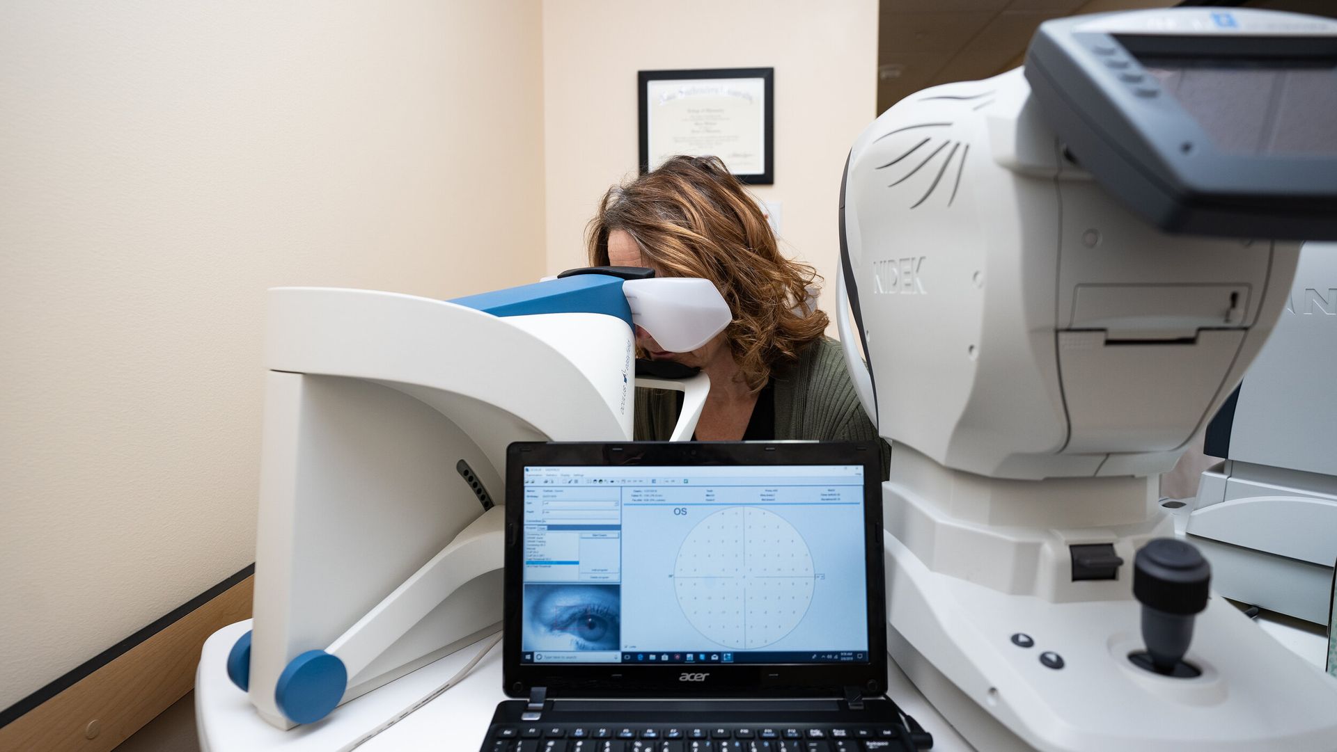 A woman is getting her eyes checked by an ophthalmologist.