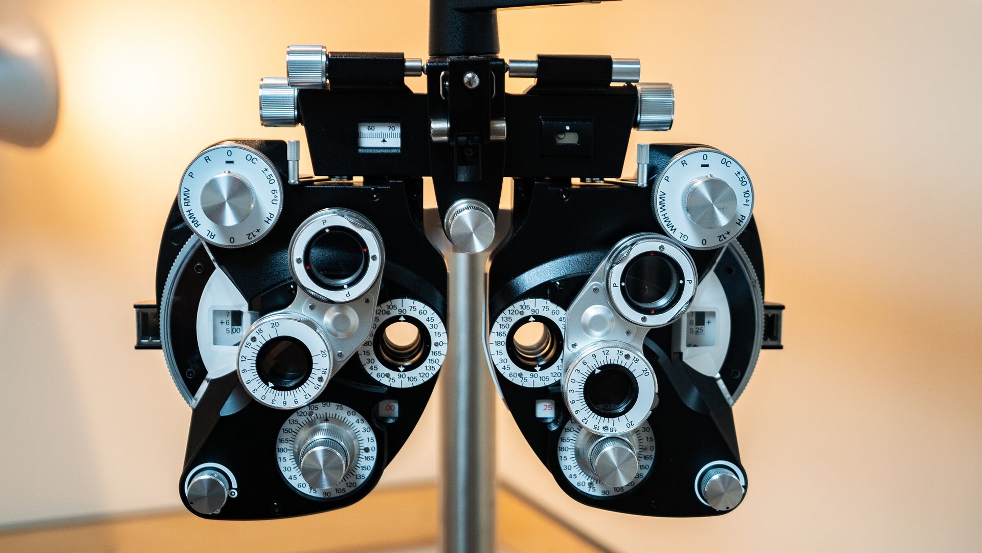 A close up of a pair of eye glasses on a stand.