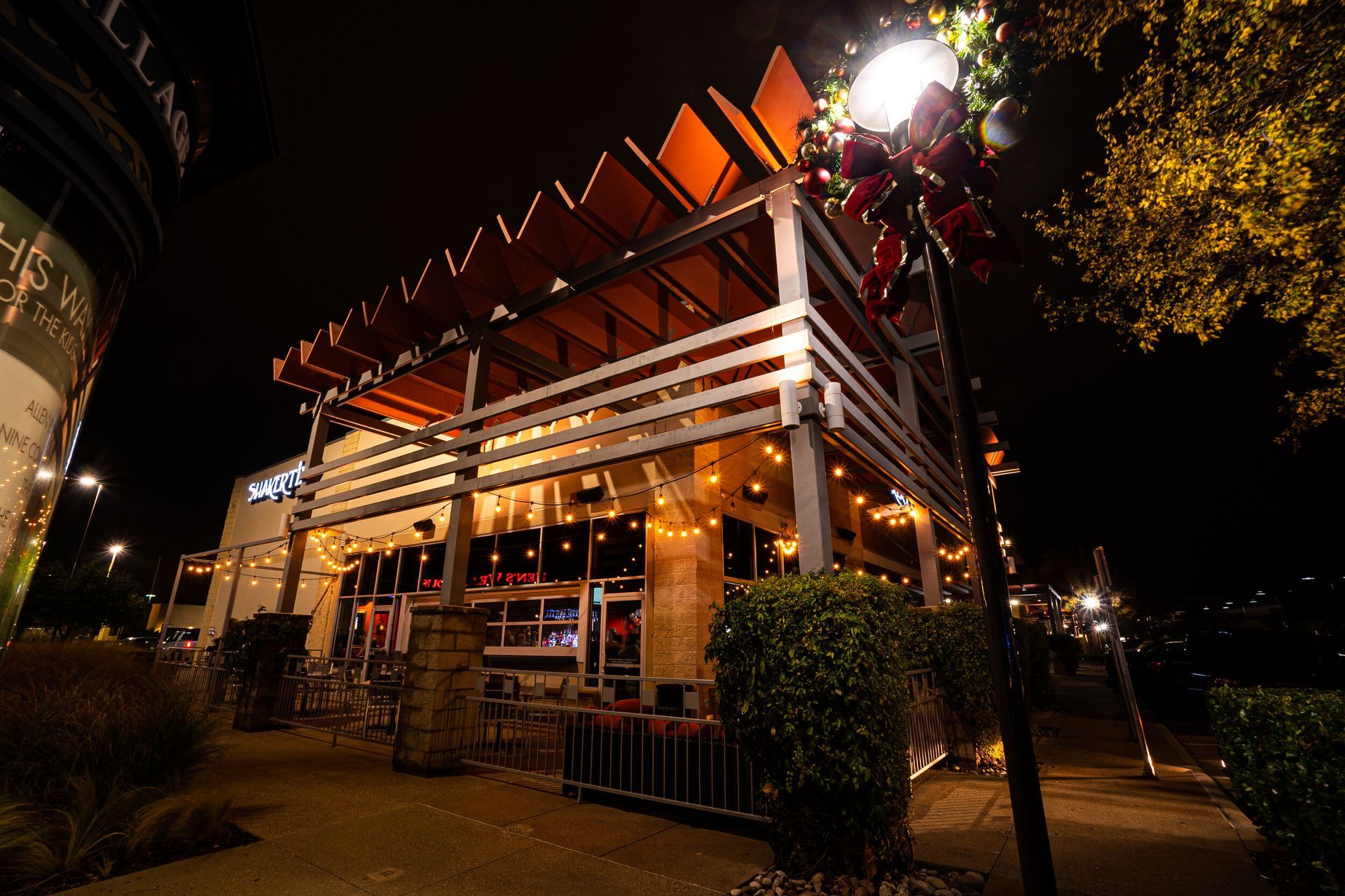 A large building with christmas lights on it is lit up at night