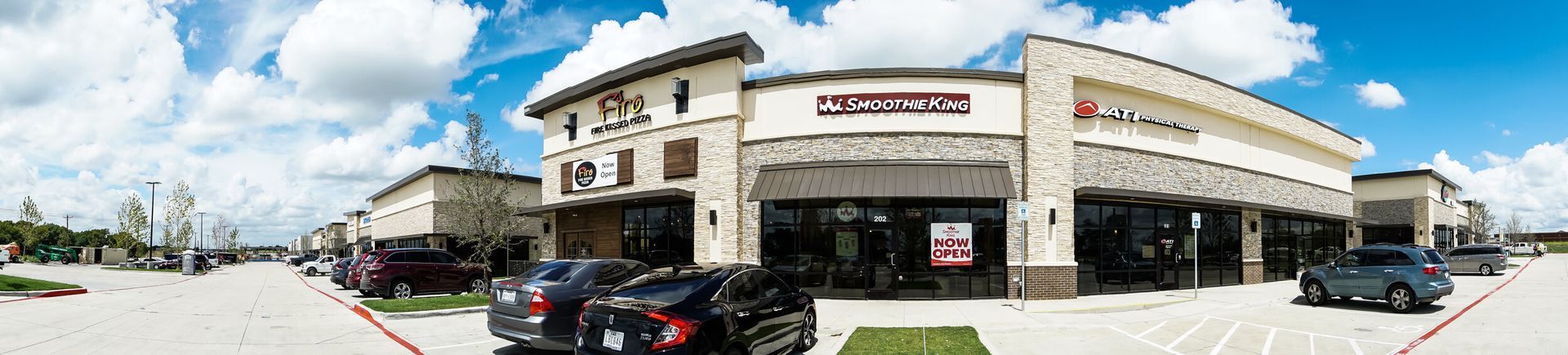 A large building with a lot of cars parked in front of it.