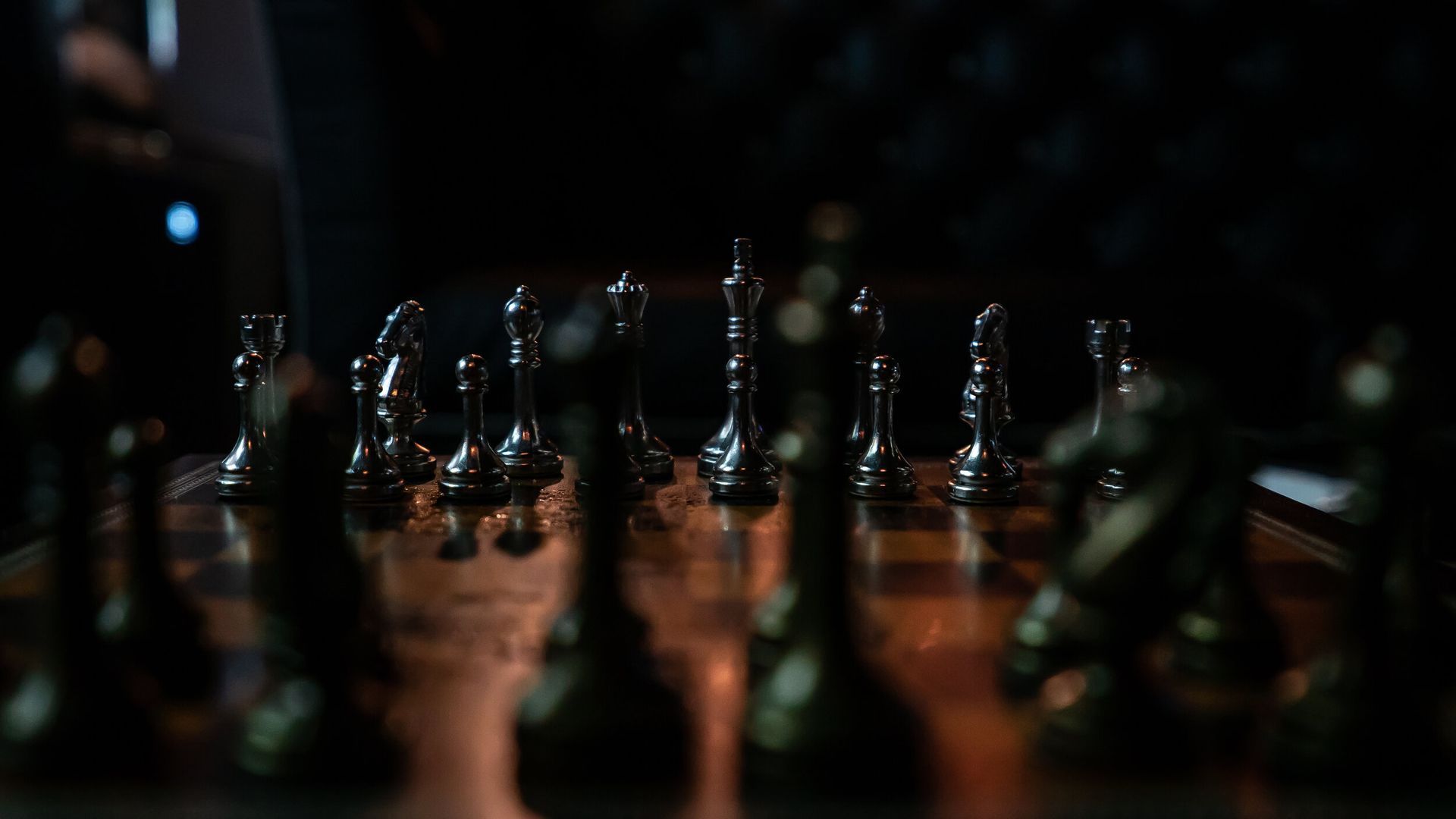 A close up of a chess board with chess pieces on it.