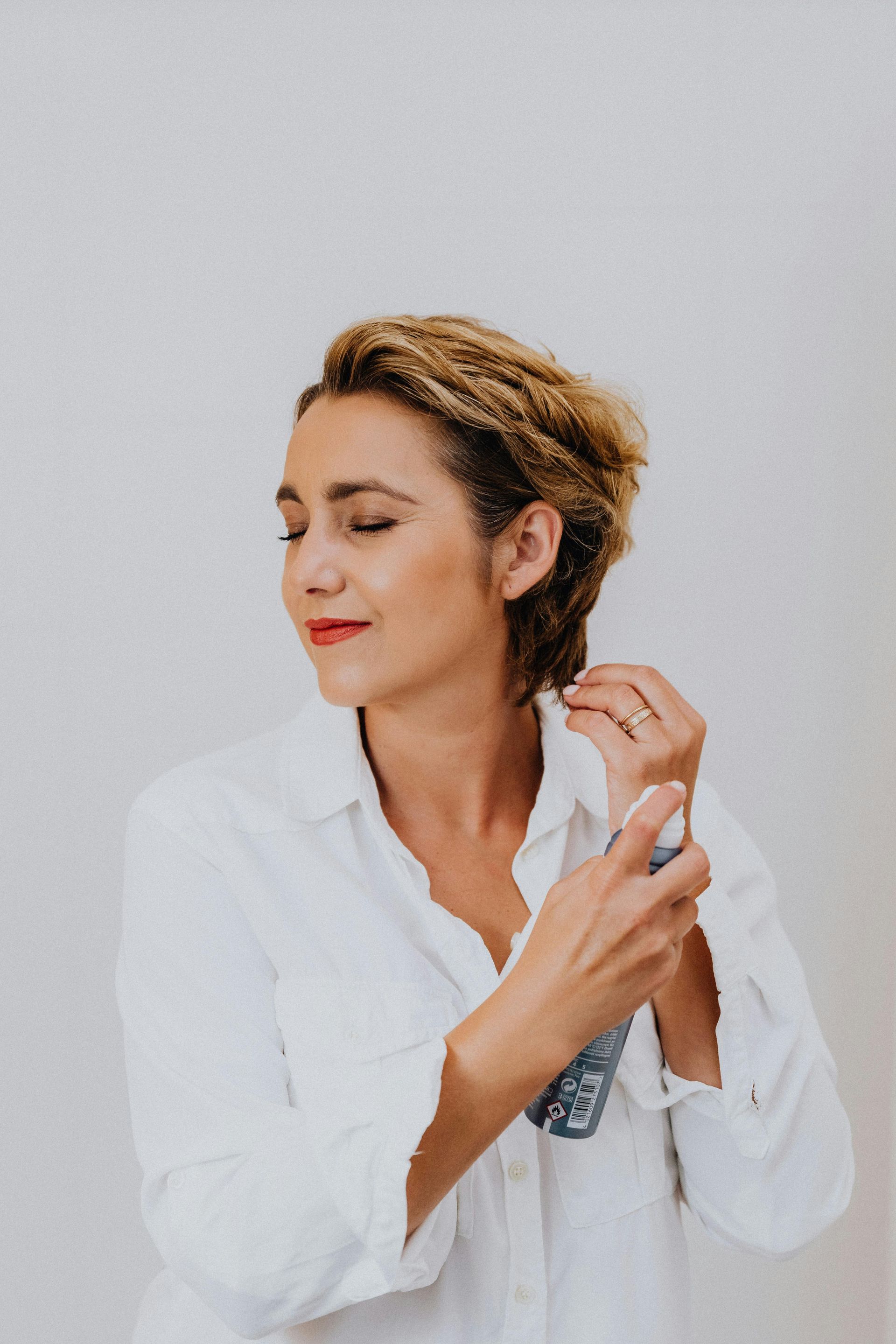 Three women hugging and smiling in a gym setting.
