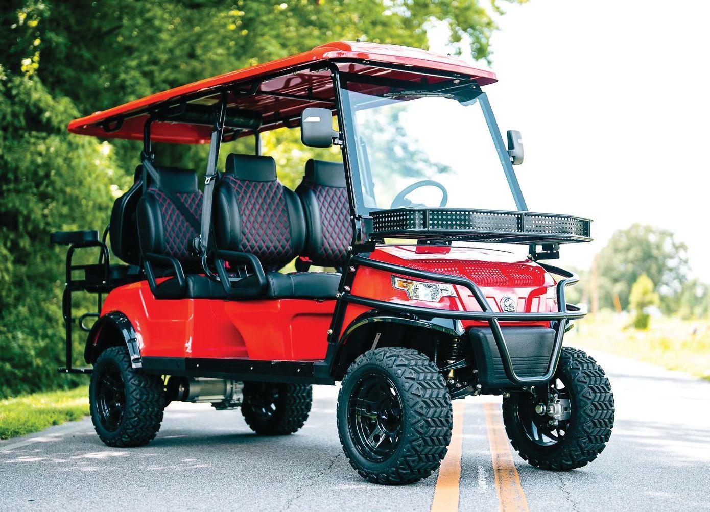 Red Epic 6-passenger golf cart on a two-lane road