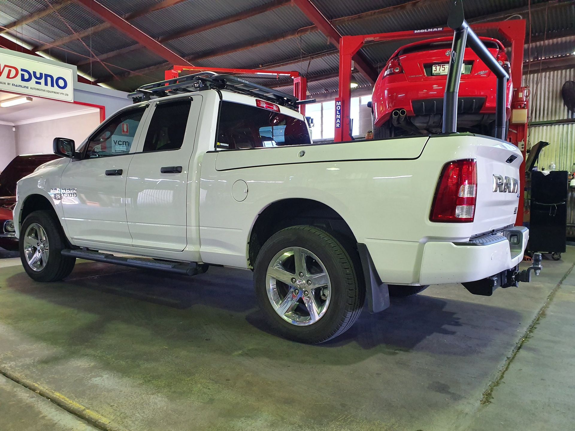 A White Car With the Hood Up in a Garage — Aitkenvale Auto & Dyno in Aitkenvale, QLD