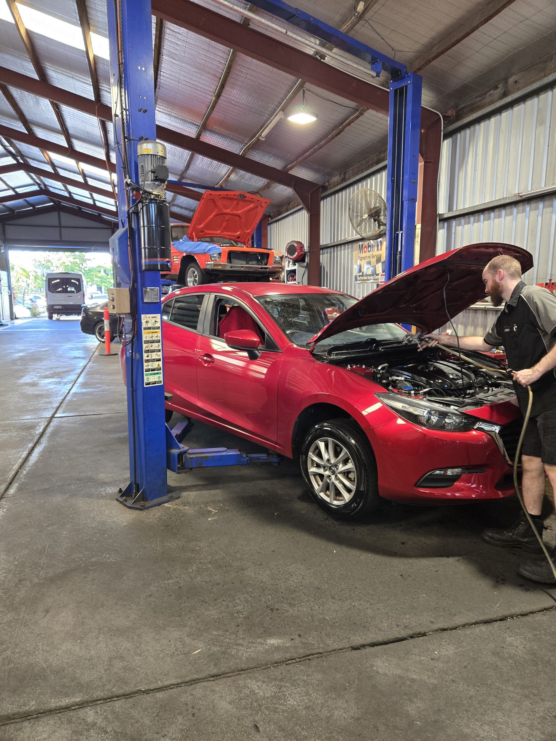 A car on the hoist is being checked by a mechanic — Aitkenvale Auto & Dyno in Aitkenvale, QLD