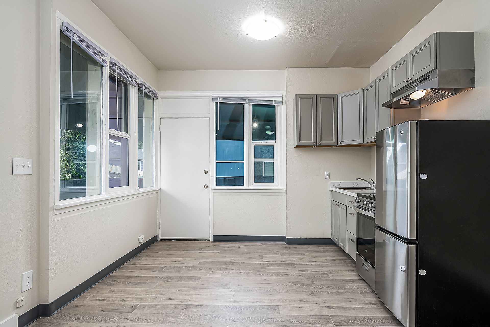 Photo of a kitchen with tall windows and plenty of natural lighting