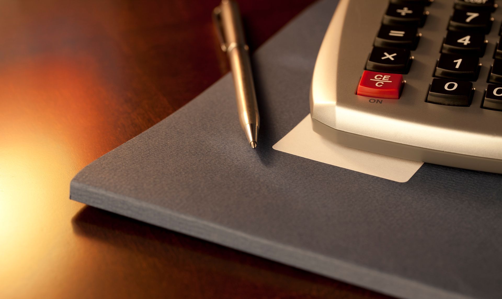 Calculator and Pen on Report | Stevens Point, WI | Glinski Klein Anderson & Haka SC