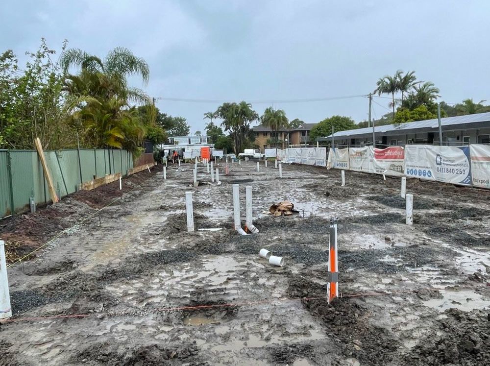 A Construction Site With A Lot Of Dirt And Pipes — Coastal Plumbing Group in Woolgoolga, NSW