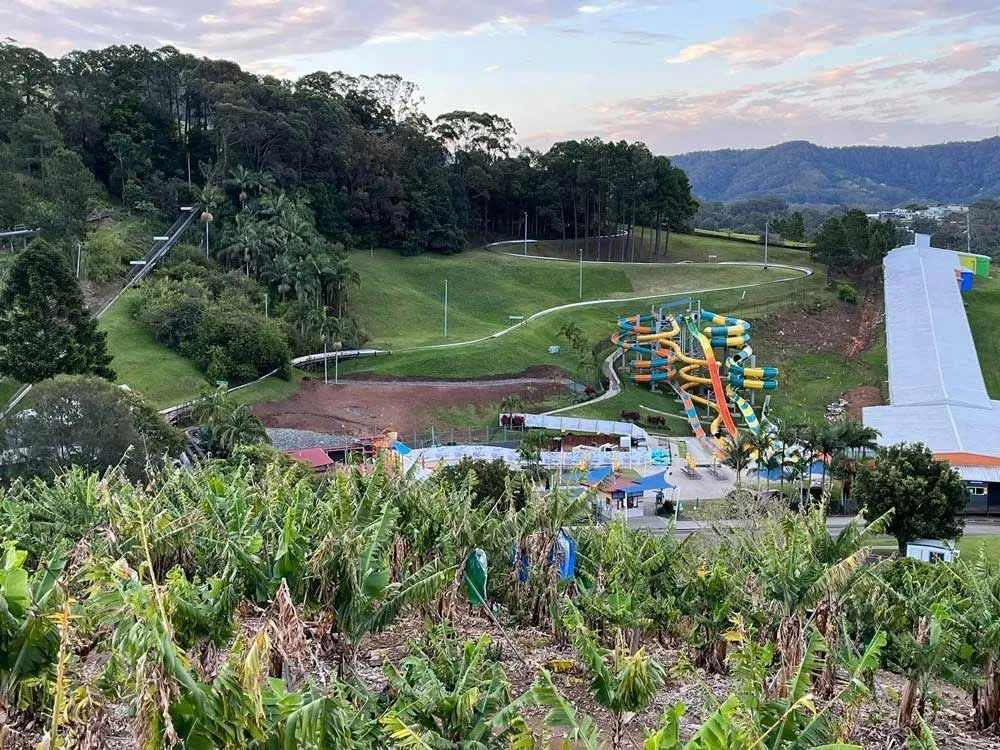 An Aerial View Of A Water Park With A Banana Plantation In The Foreground — Coastal Plumbing Group in Woolgoolga, NSW