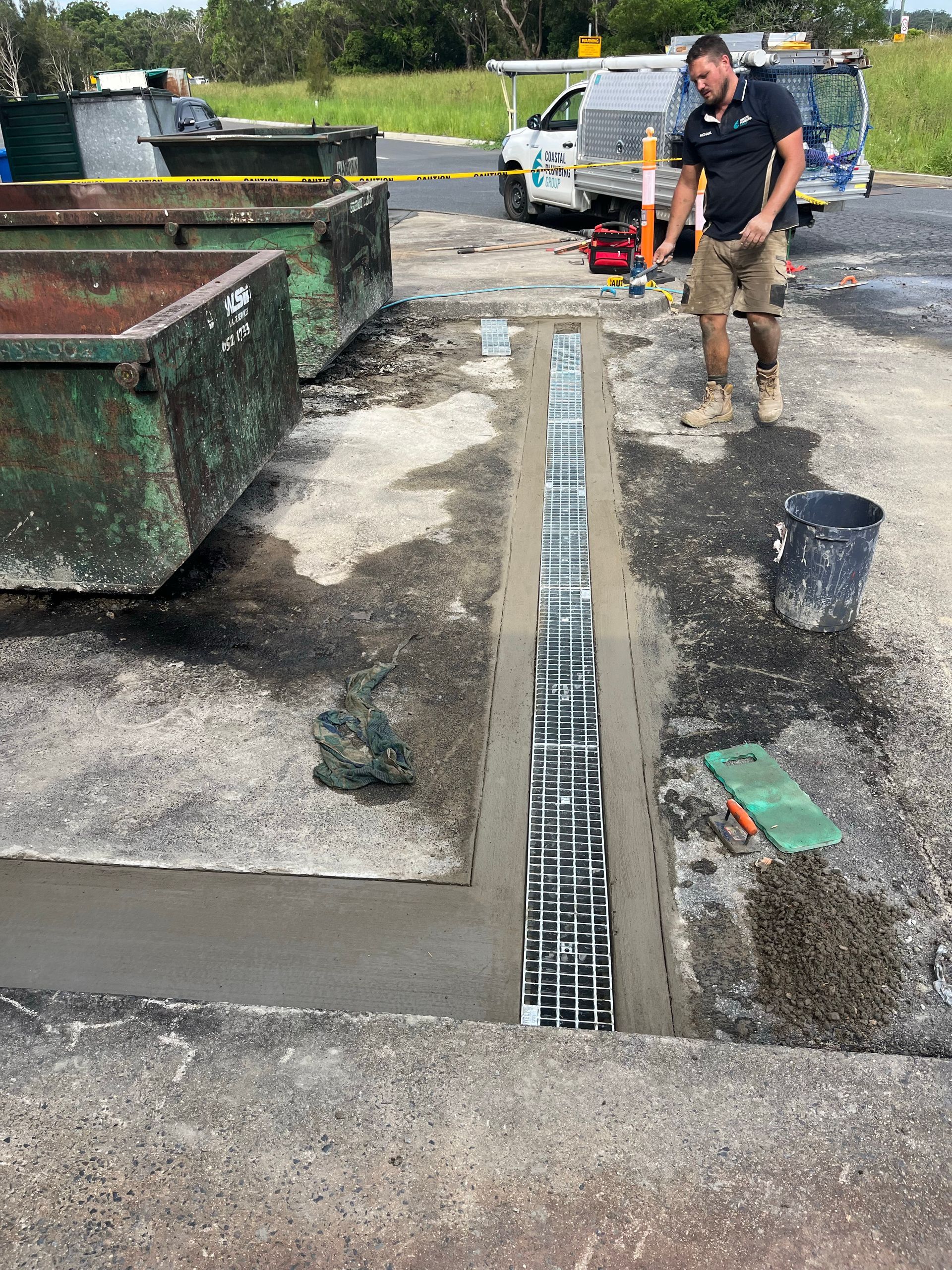 A Person Is Fixing A Faucet In A Kitchen Sink — Coastal Plumbing Group in Coffs Harbour, NSW