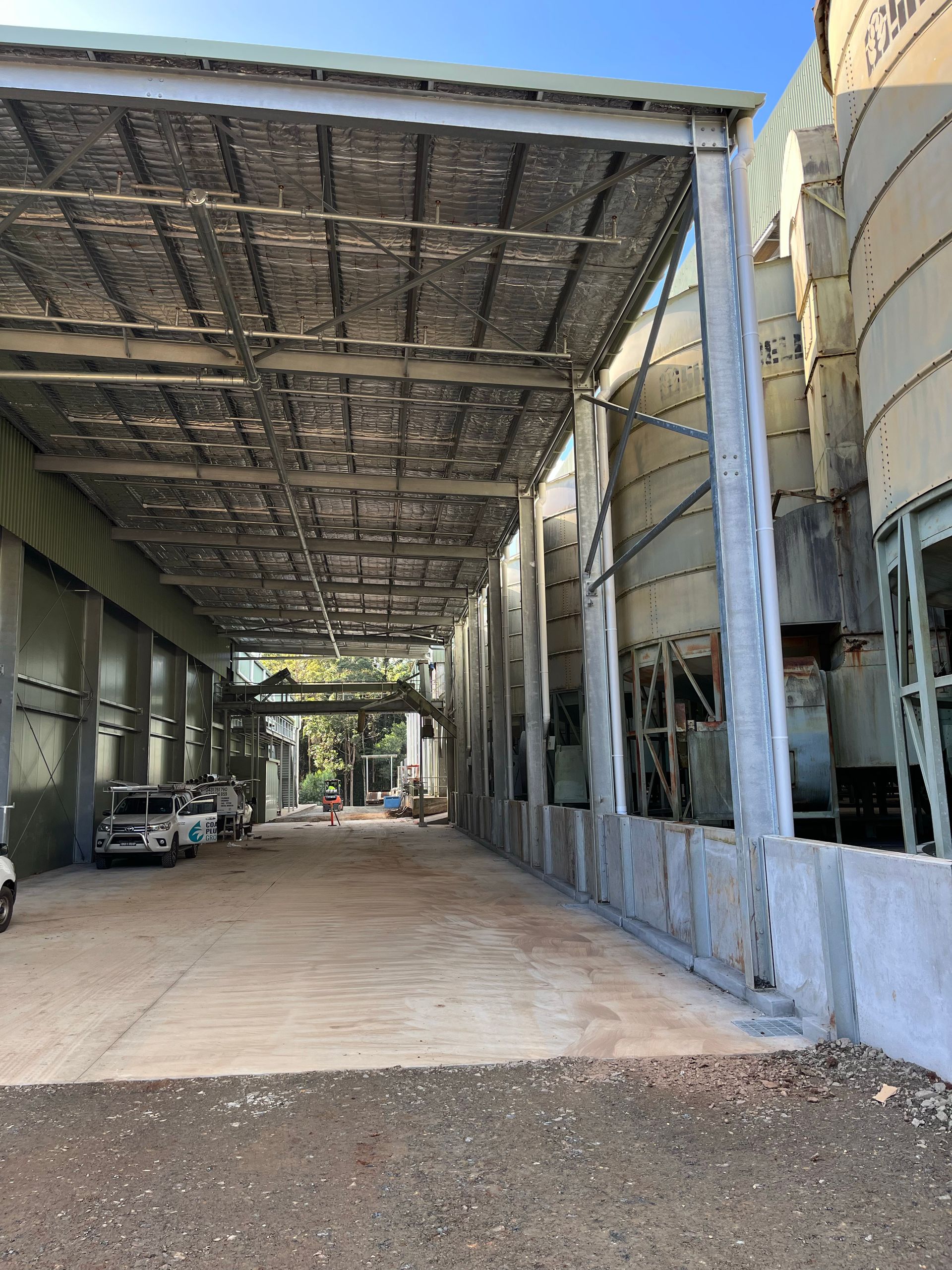 A Bathroom With A Toilet, Sink, And Plumbing Tools On The Floor — Coastal Plumbing Group in Coffs Harbour, NSW