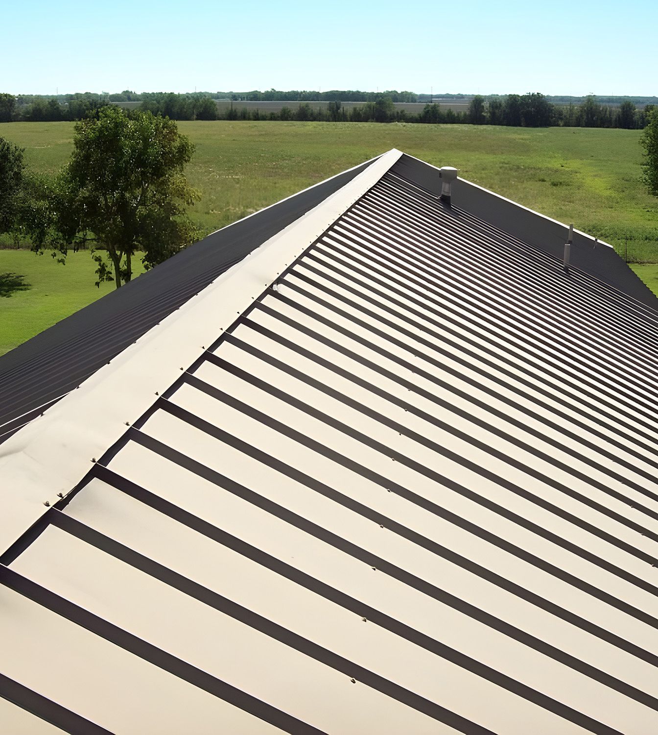A Metal Roof With A Central Ridge — Roof Repairs Coffs Harbour -Coastal Plumbing Group in Woolgoolga, NSW